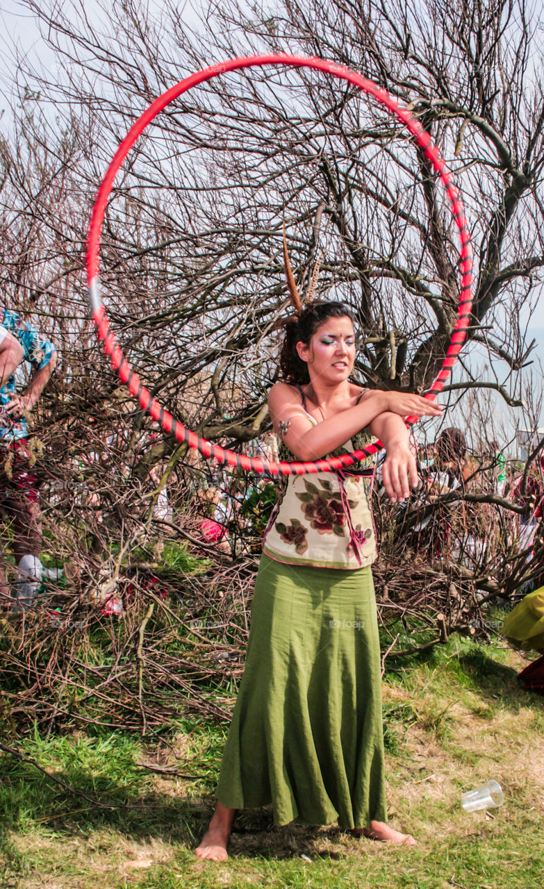 A woman dances with a hula hoop, at Hastings Traditional Jack in the Green, U.K. 2008