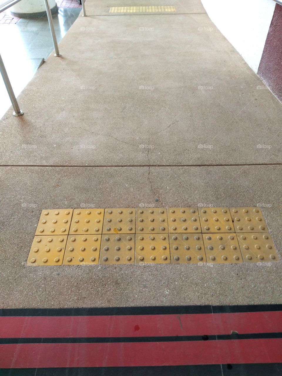The surface of the path of the wheelchair with anti-slip pads on the slope to prevent accidents.