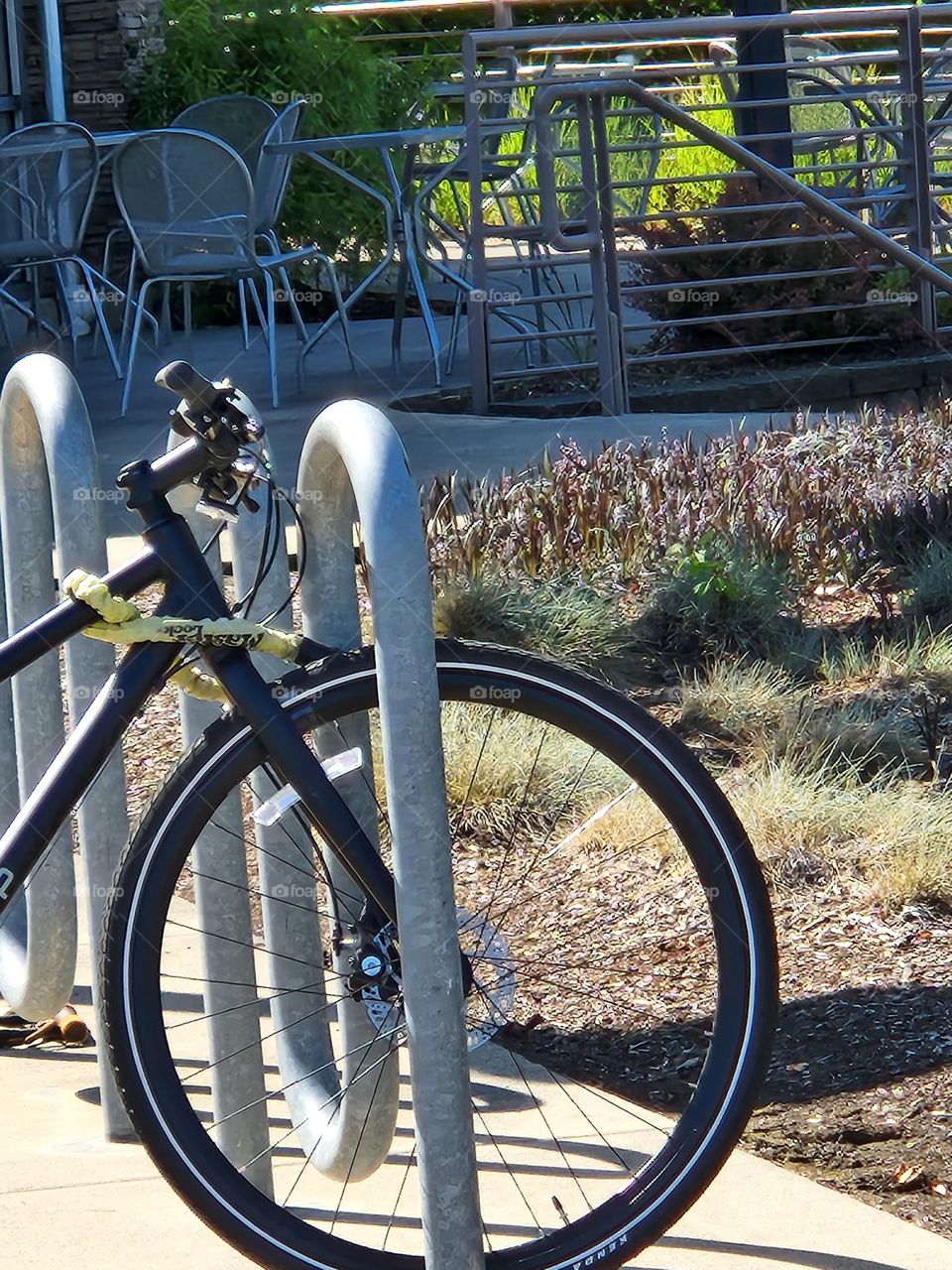 bicycle parked in front of outdoor seating at a Suburban market