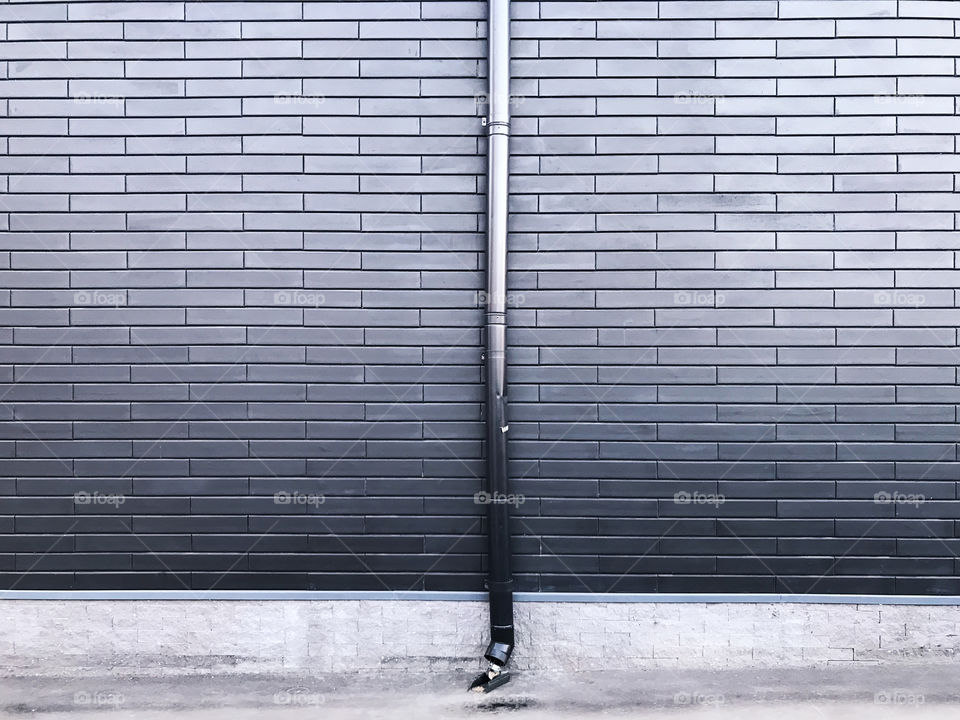 Brick wall with sewer in front 