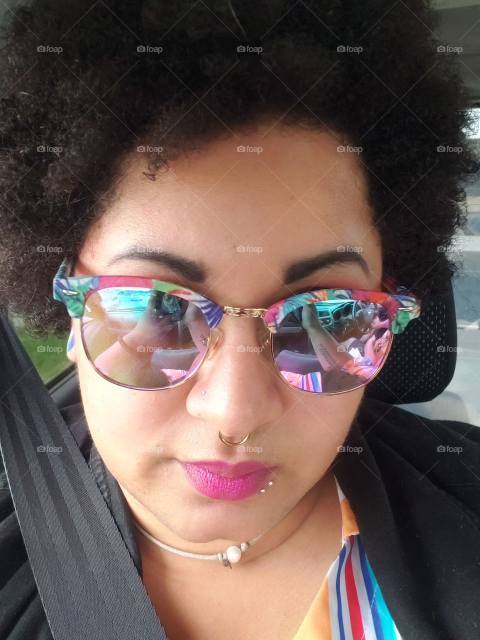 reflective sunglasses on ethnically ambiguous girl with an afro