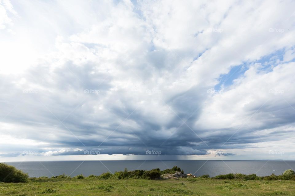 Big dramatic cloud formation over the ocean when rain is approaching in the horizon 