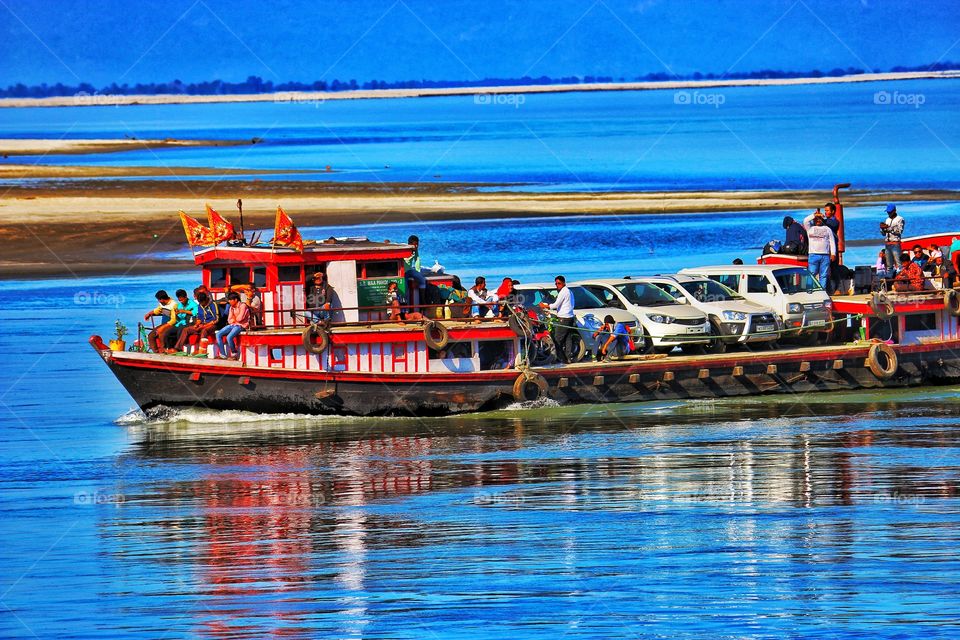 Steamer sailing on Mighty Brahmaputra carrying peoples along with cars