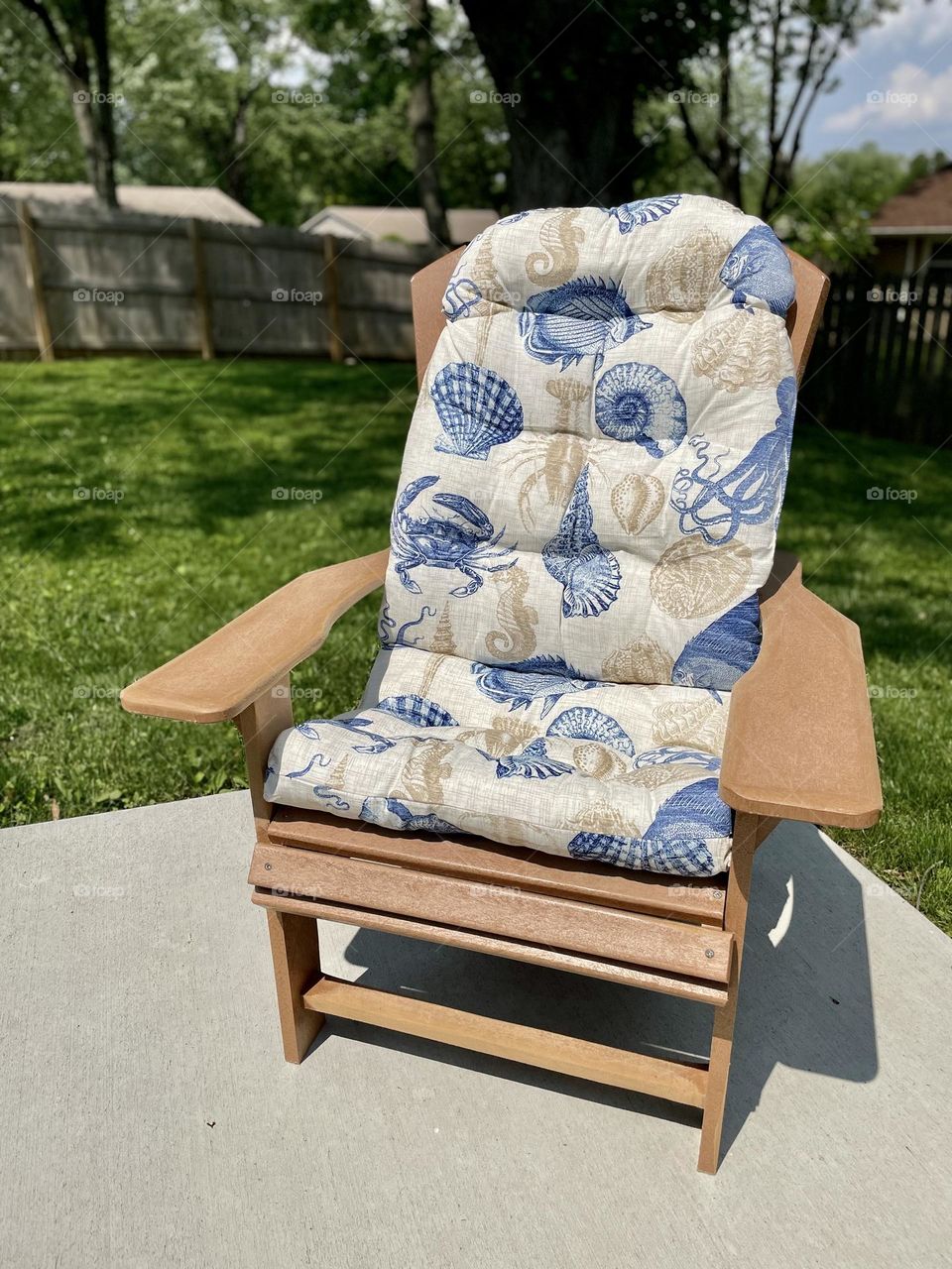 Adirondack chair on patio in the backyard, relaxing at home for the summertime, sunshine and relaxation, summertime fun at home