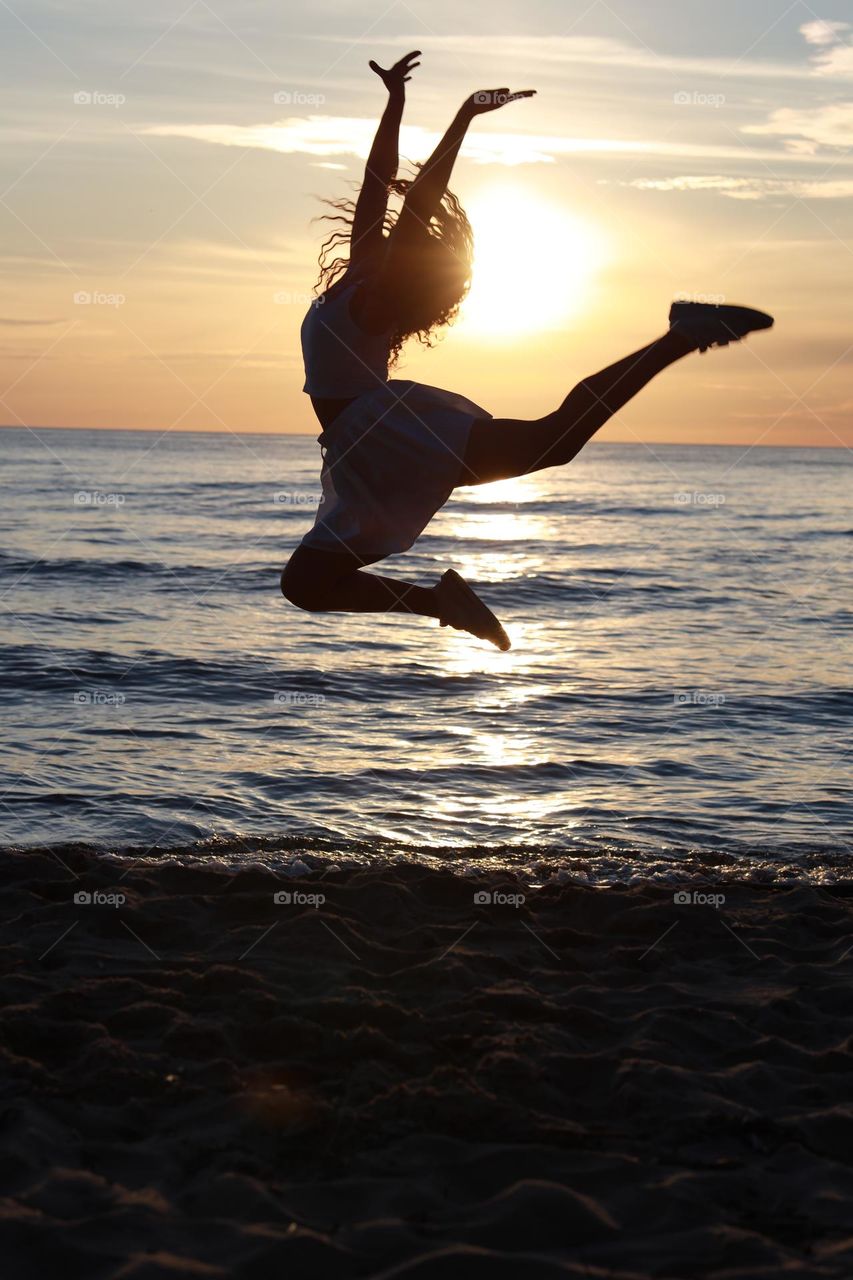 Dancing girl in the sunset rays.