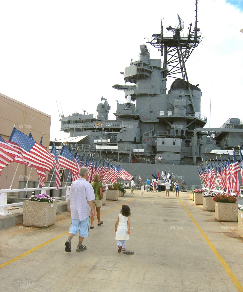 man and child walking on USS Missouri Memorial, Pearl Harbor, Hawaii