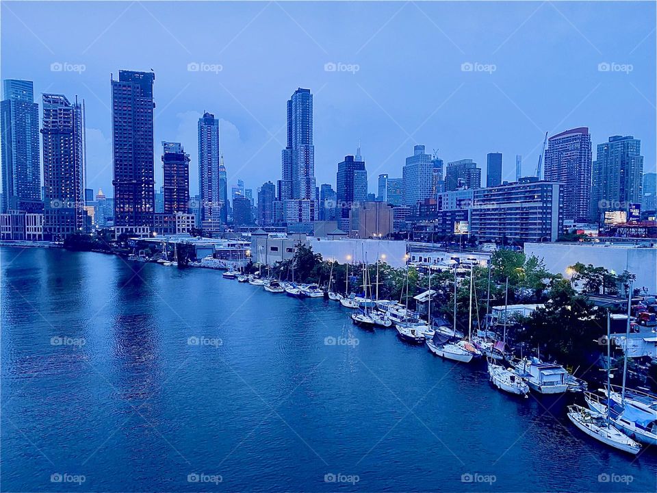This is “Newtown Creek” seen from the “Pulaski Bridge” in LIC, Queens on a warm balmy Indian summer evening in September 2023. The cityscape seen in the distance on the right includes “Manhattan”. Hypnotic Productions