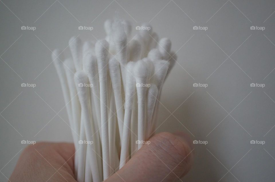 A hand holding swabs