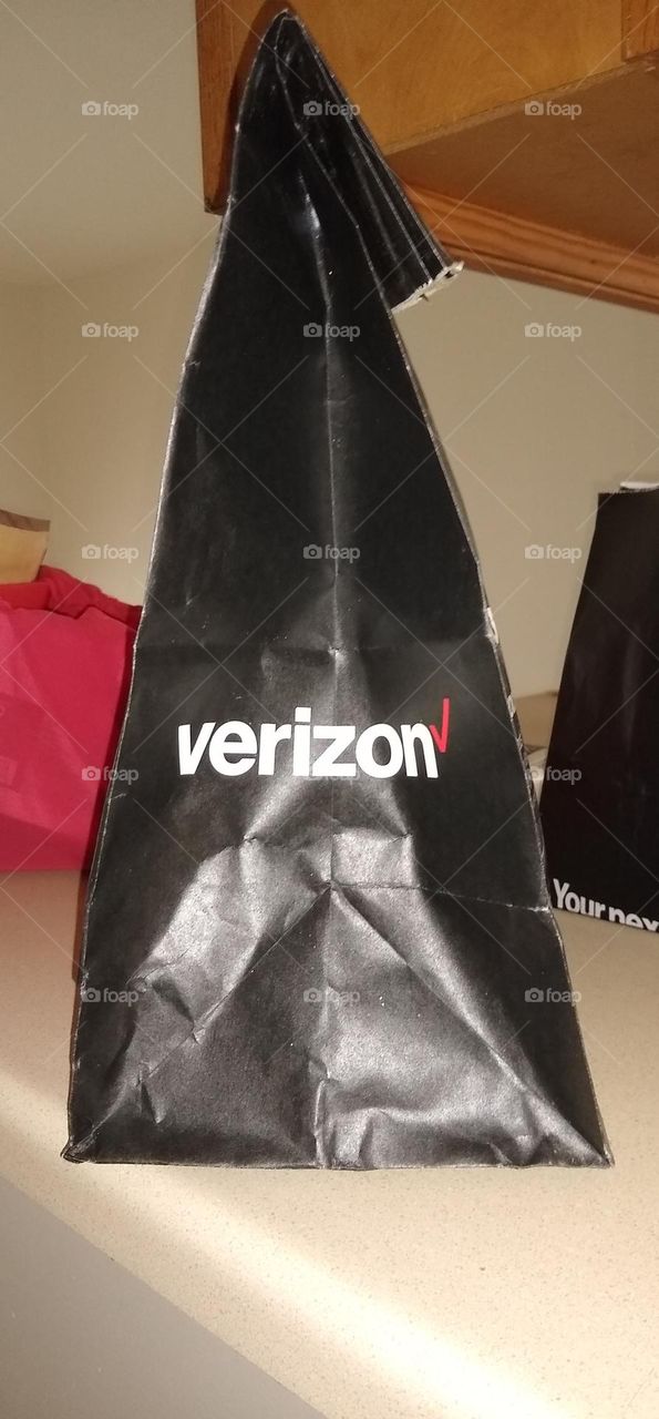 Black paper bag in the shape of a triangle
