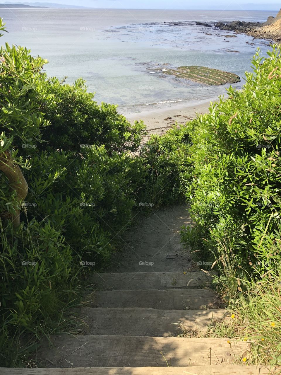 Stairs leading down to the rocky beach on Oregon coast. 