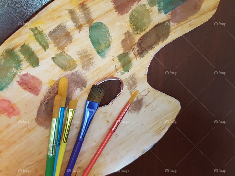 High angle view of brushes on palette on table