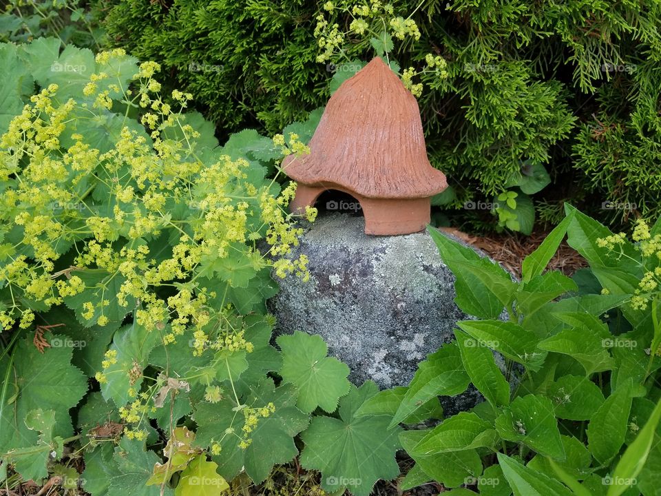 Terra cotta fairy house in garden