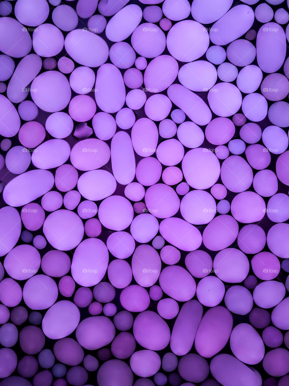 Random purple circular objects in a soft umbre shading, round shapes, egg shapes 