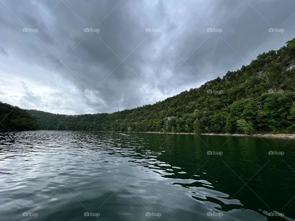 A storm rolling through the mountains and over the lake