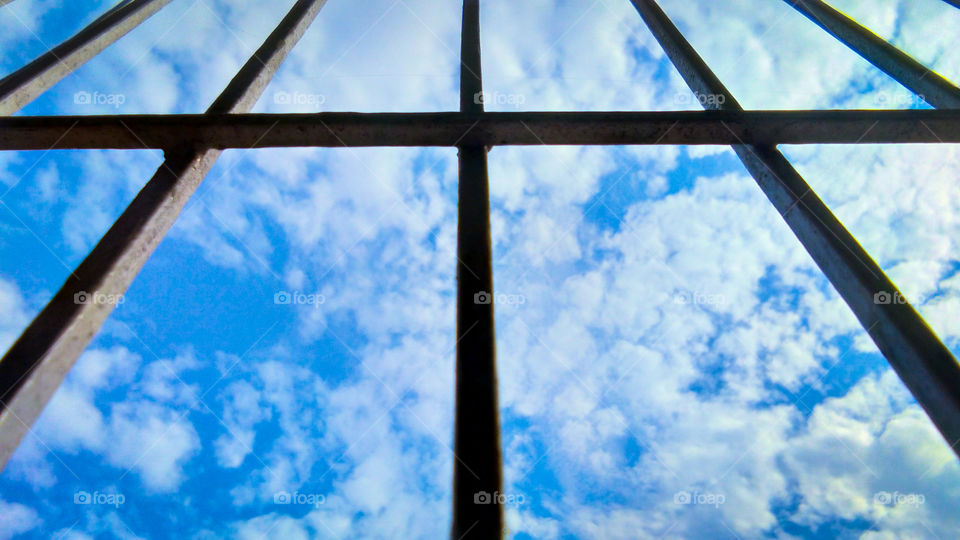 cloud and sky through silhouette window frame
