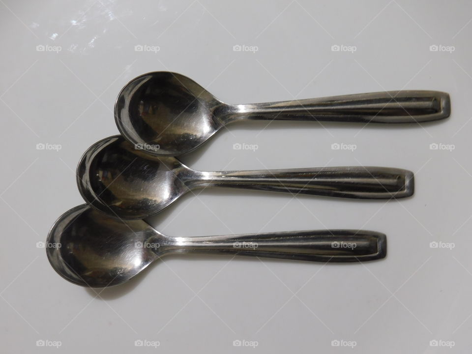 Table Spoons Arrangement on white background.