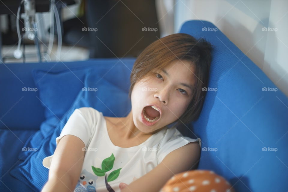 Tired Japanese girl on sofa