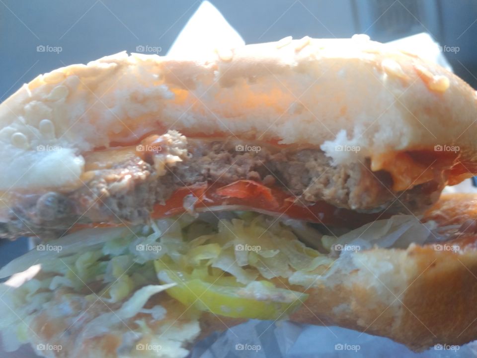 Having a Carl's Jr. Super Star hamburger for lunch.