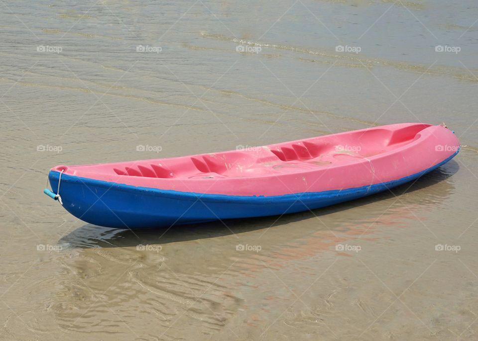 Colourful kayak on the beach.