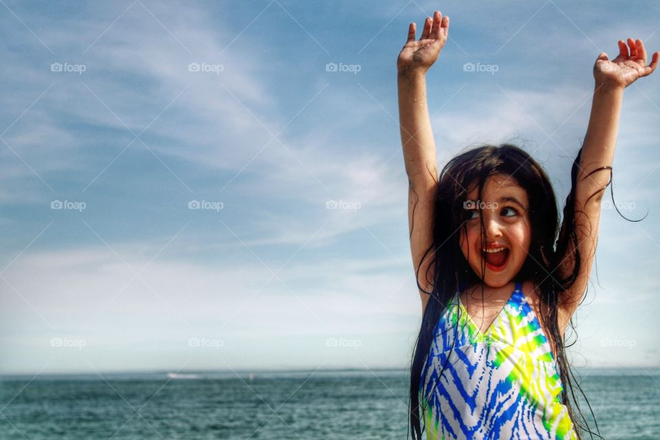 Happy girl standing near beach
