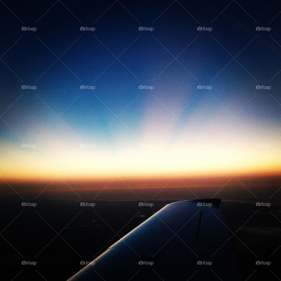 Sunrise in Plane Sight. Beautiful rays of golden sunshine peaking over the horizon! Took this off of a plane wing on the way back from the Keys!
