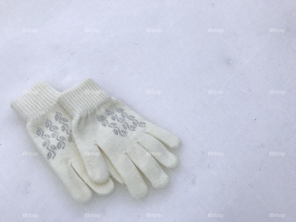 White gloves on a white snow