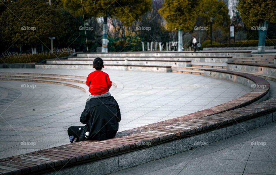 A child is on his father's head