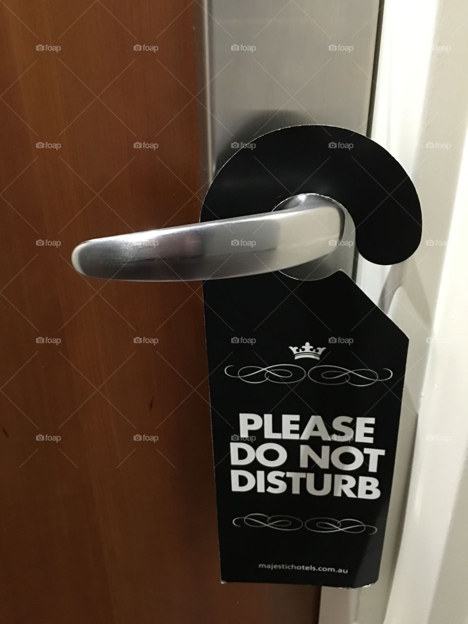 Do not disturb hanging doorknob sign in luxury hotel