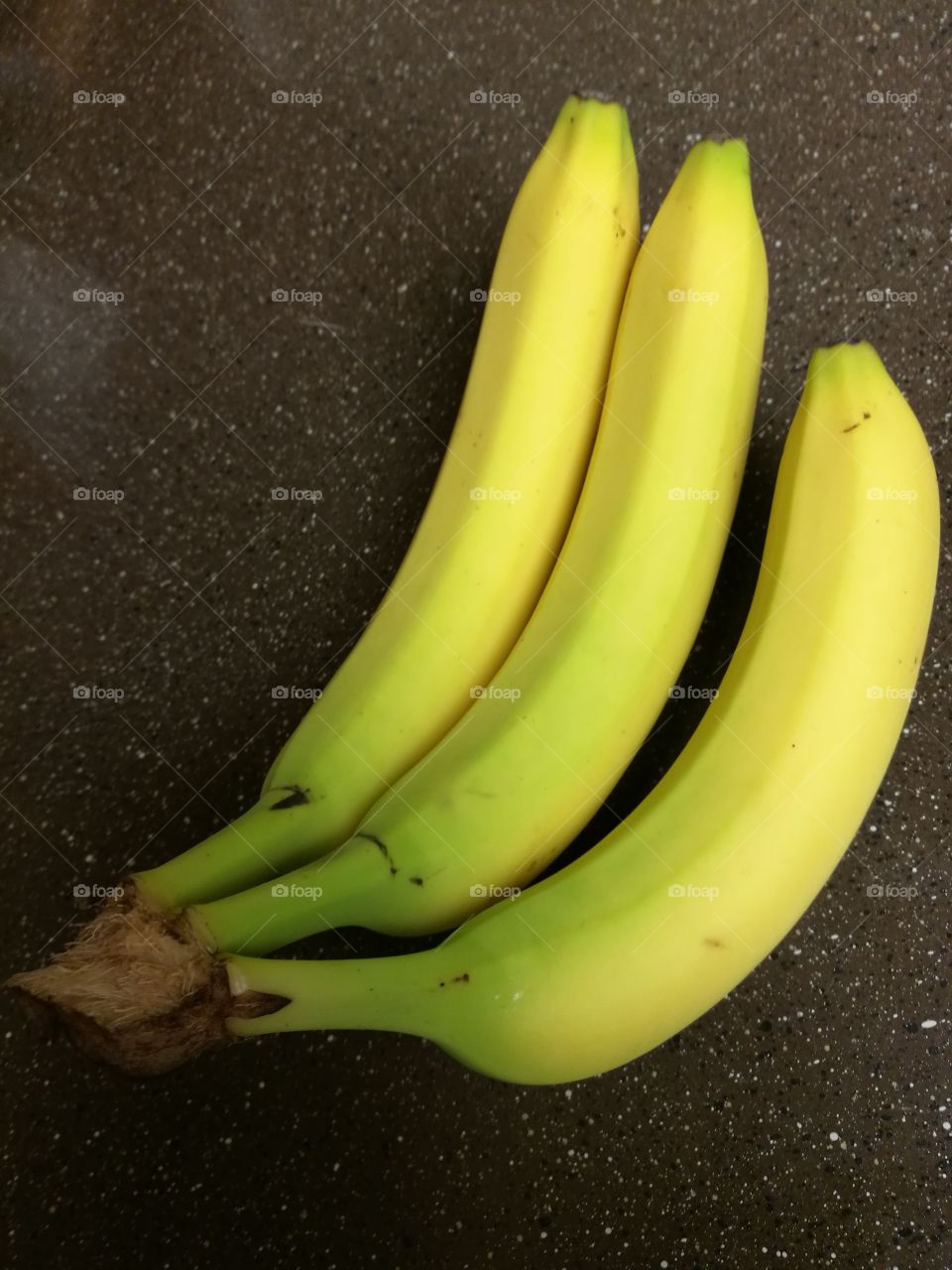 Ripe bananas on brown counter