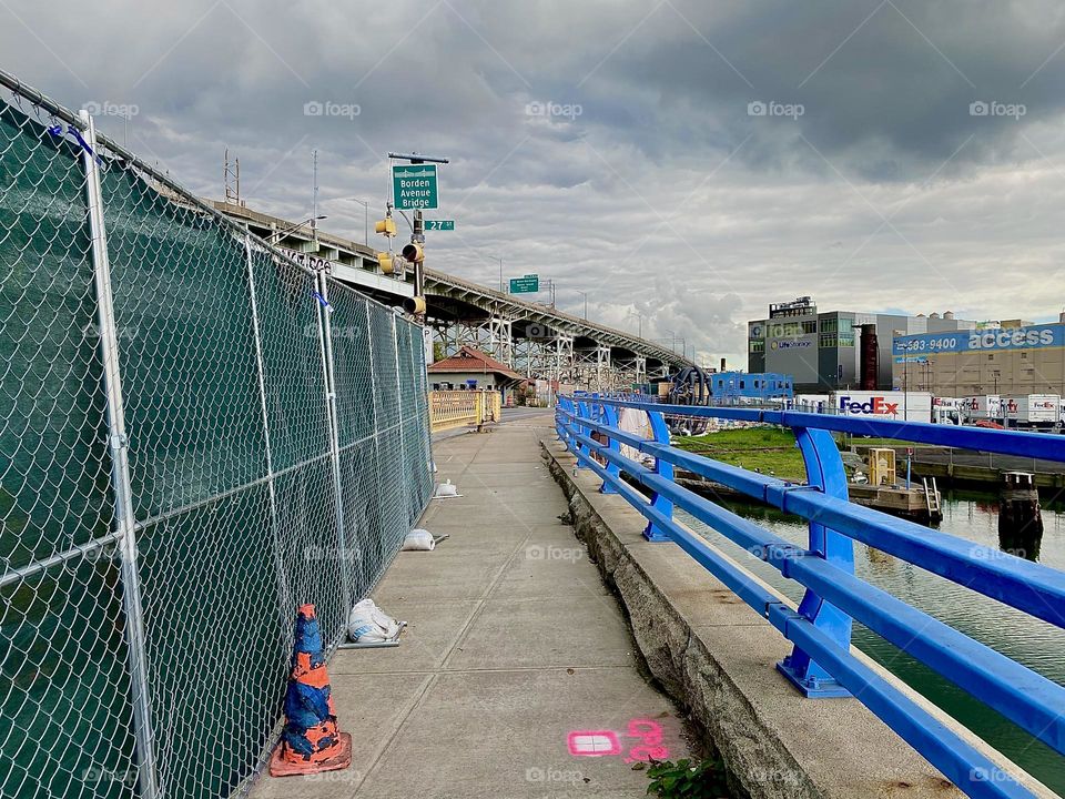 This is the “Borden Avenue Bridge” leading over “Dutch Kills”, an ocean inlet of the “East River” much like “Newtown Creek” by the “Pulaski Bridge” in LIC, Queens. In the background we see the “Brooklyn Queens Expressway”. 2023. Hypnotic Productions