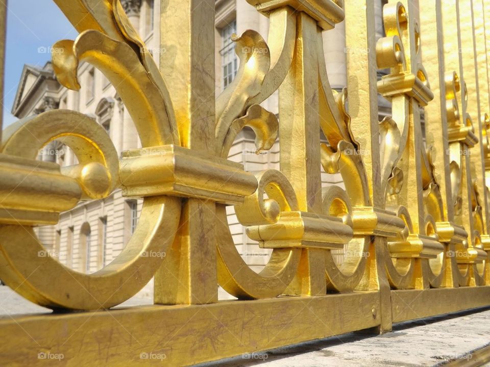 gold all in my chain. fence to the palace of versailles in france
