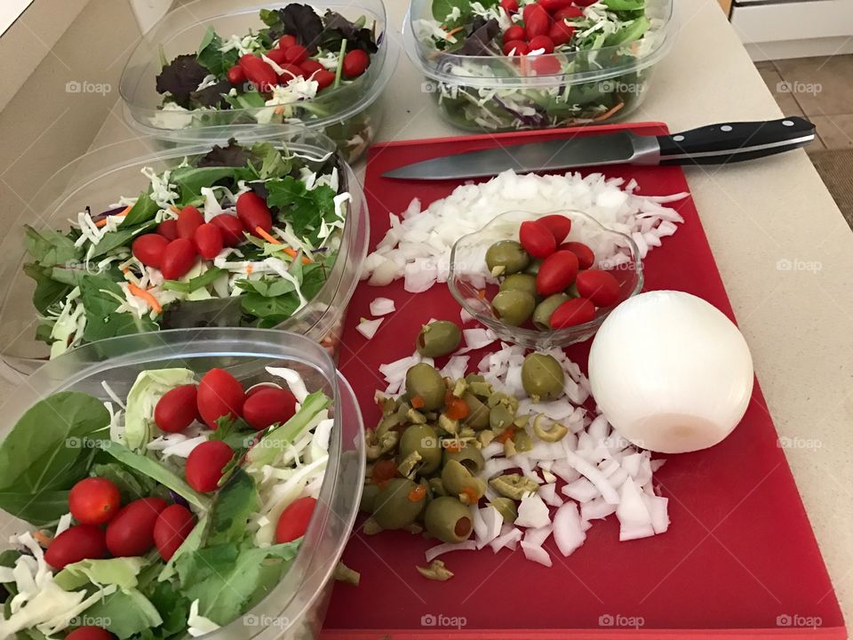 Preparing fresh vegetables for salads.