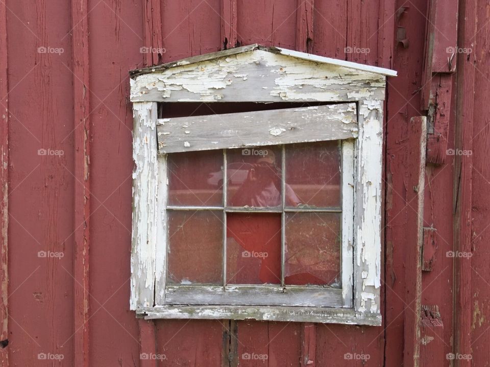 Side of red barn , farming . Old barn window.