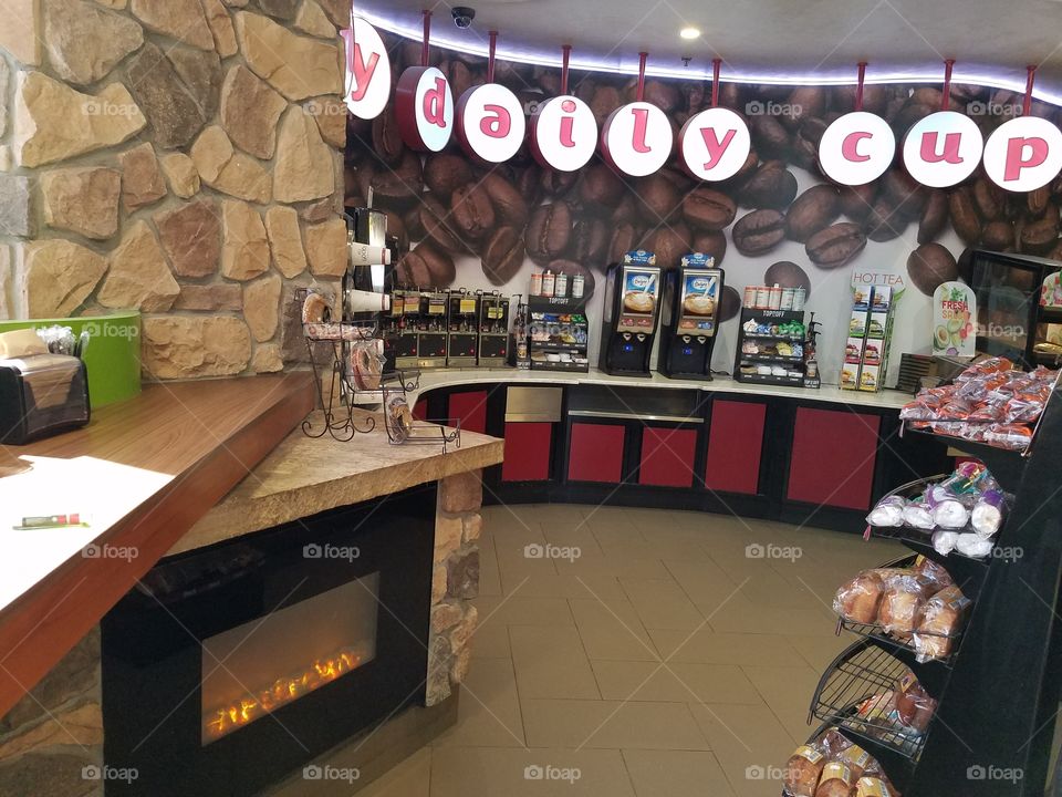 A particularly extravagant coffee counter at the gas station on the way to the airport in Denver Colorado.   I'd never seen a gas station with a fire place before.