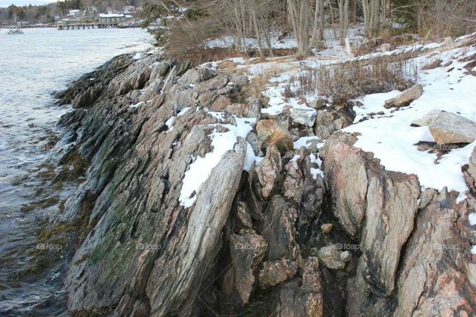 Light snowfall on the water's edge.