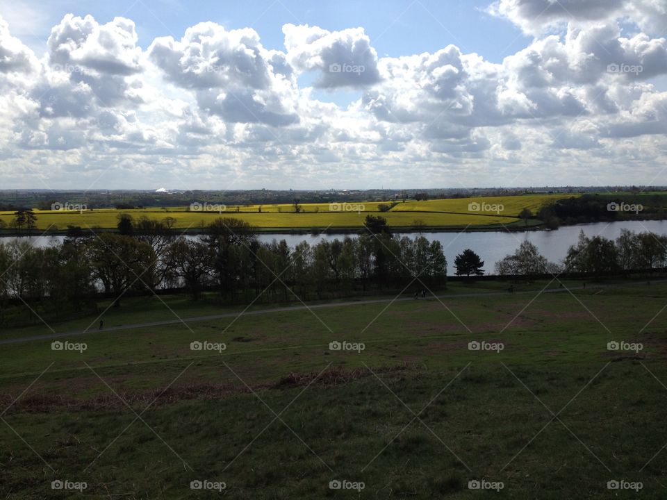 Big white fluffy clouds over Bradgate Park. Beautiful yellow cornfields in the distance. 