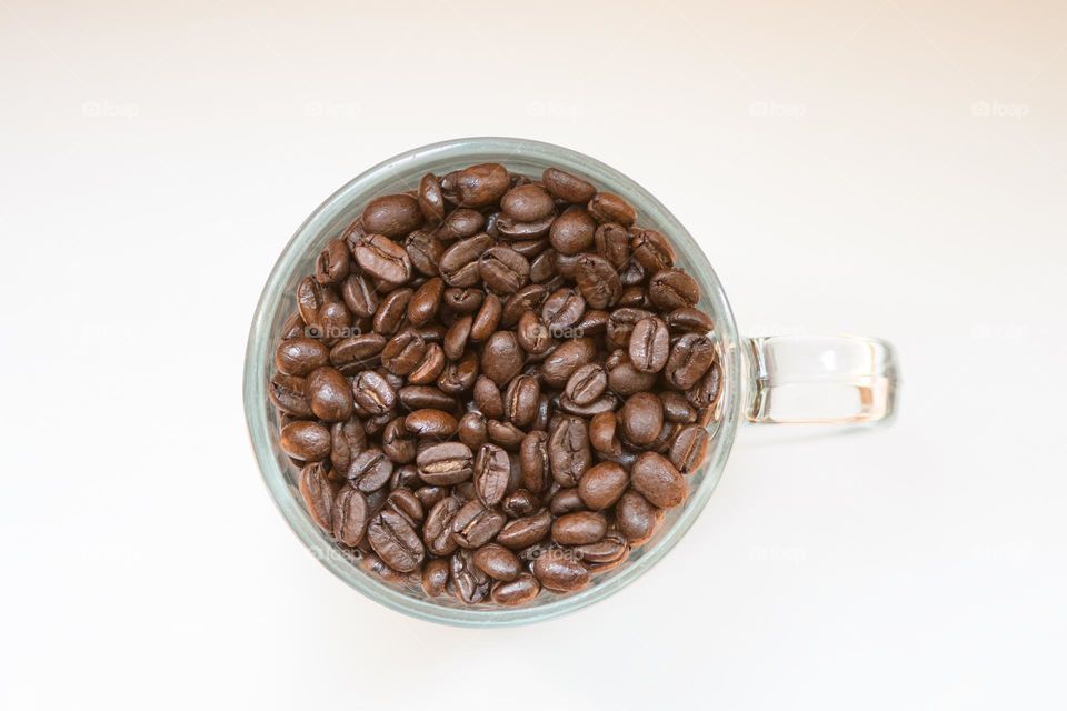 Coffee beans in a glass mug