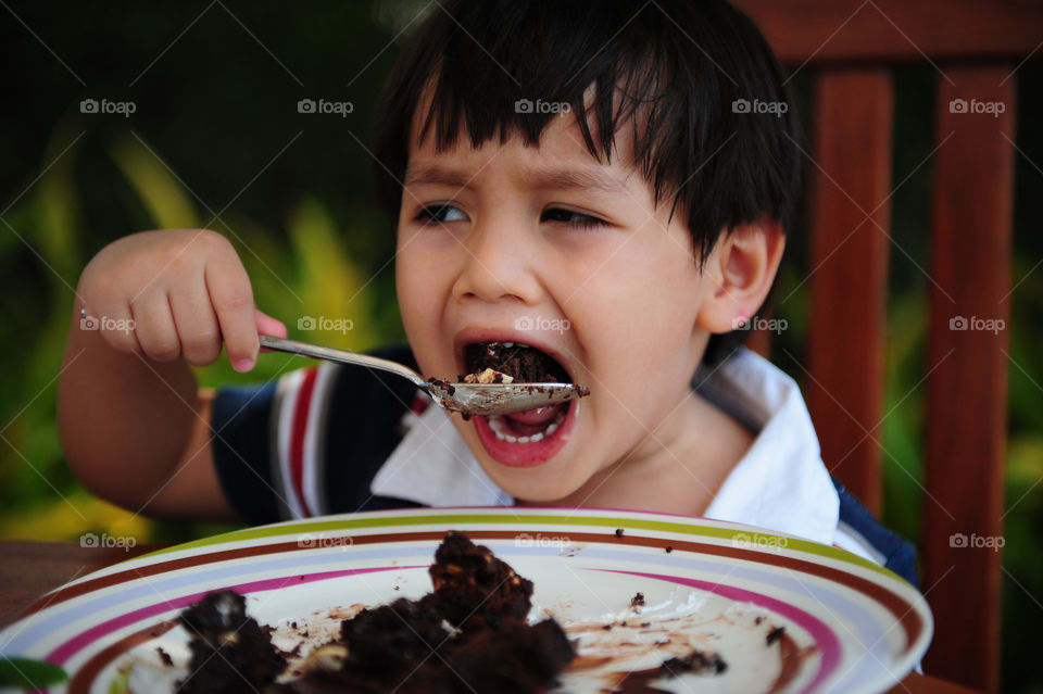 Yummy chocolate cake. Thitiwin enjoying cake but not sure his mouth is big enough