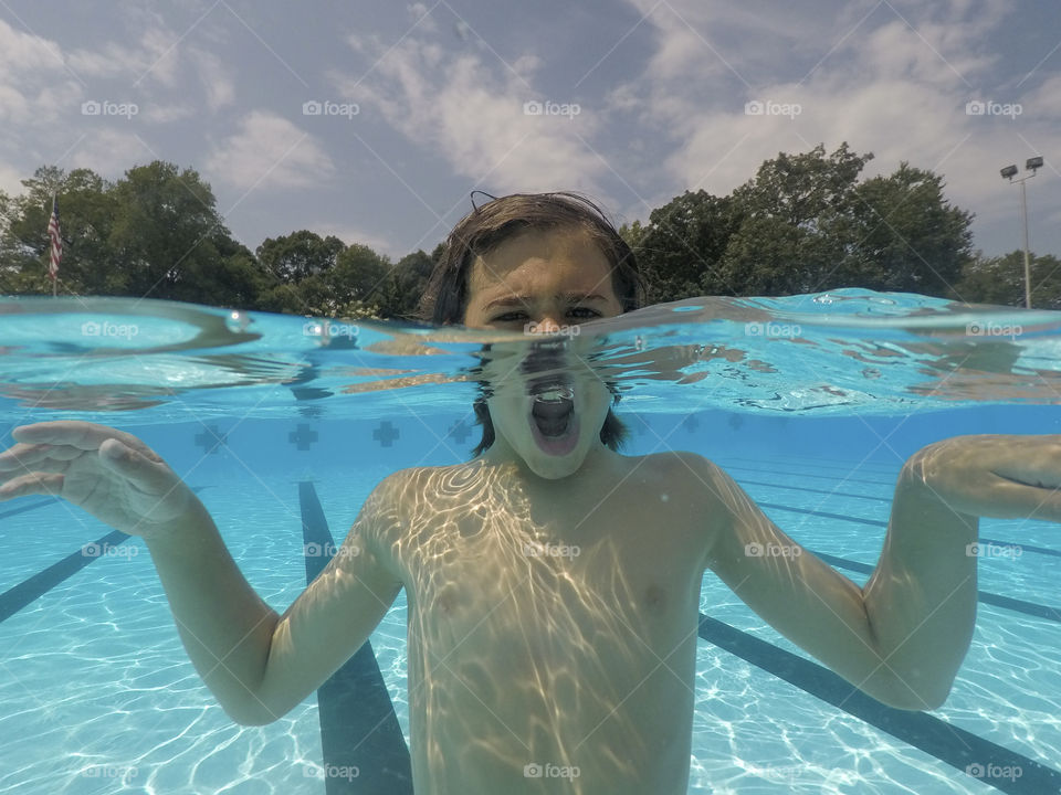 Portrait of a Boy playing in a pool