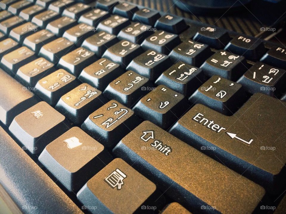 close up of a black keyboard english and thai alphabet
