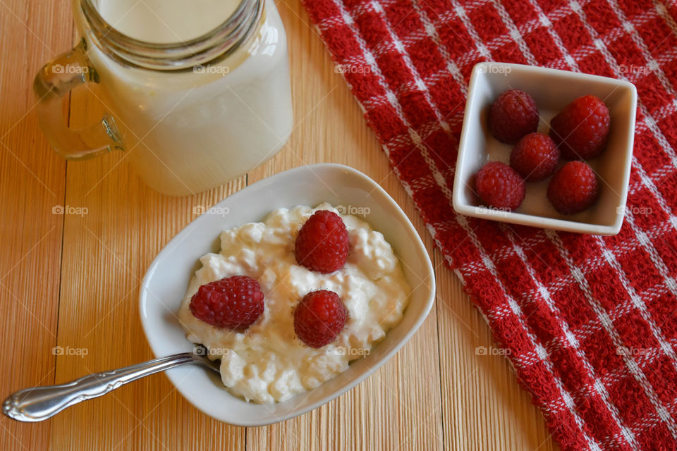 Cold glass of milk with fruit and cottage cheese