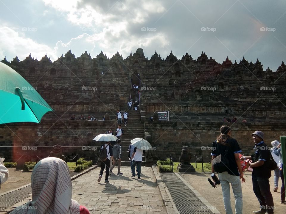 A part sunny and part cloudy front side of the Borobudur Temple at Magelang, Indonesia