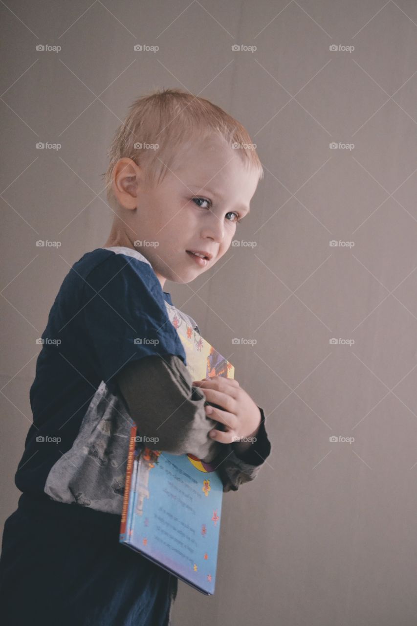 Boy with a book. Little boy waiting for his good night story