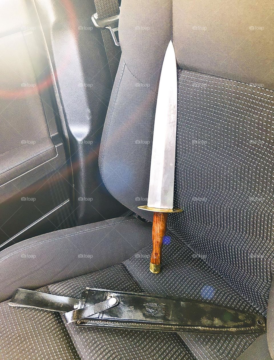 A sharp Arkansas Toothpick sitting on the front passenger seat of a car along with its leather sheath in contemporary time. A considerable number of Confederate soldiers were equipped with this general purpose, iconic dagger in the Civil War.