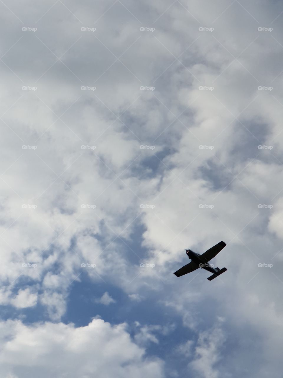 Clouds sky and flying airplane