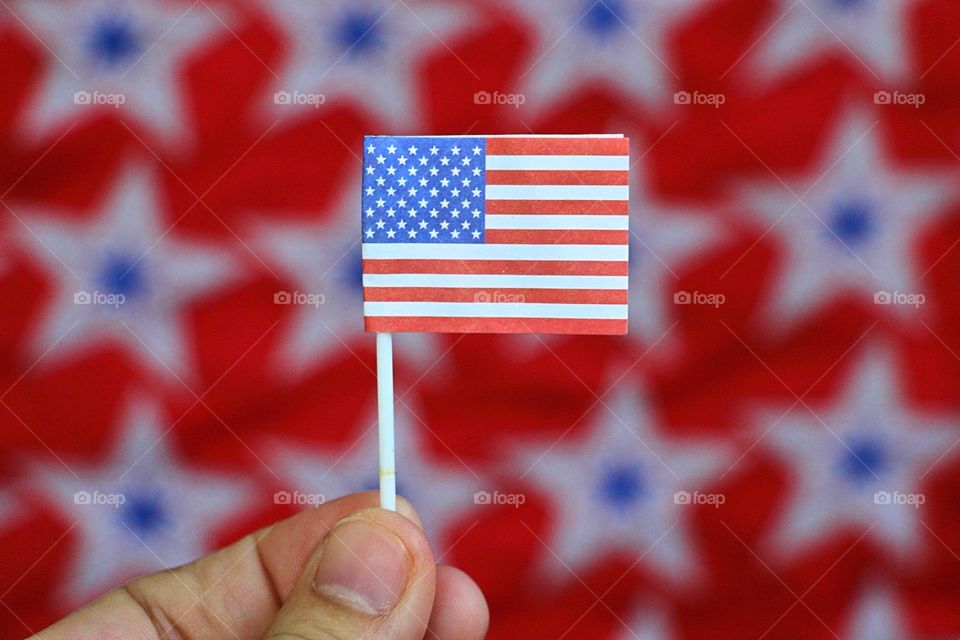 Hand holding American flag