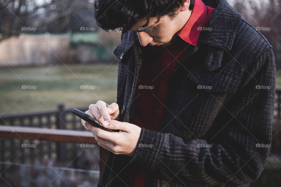 Young man working on his phone