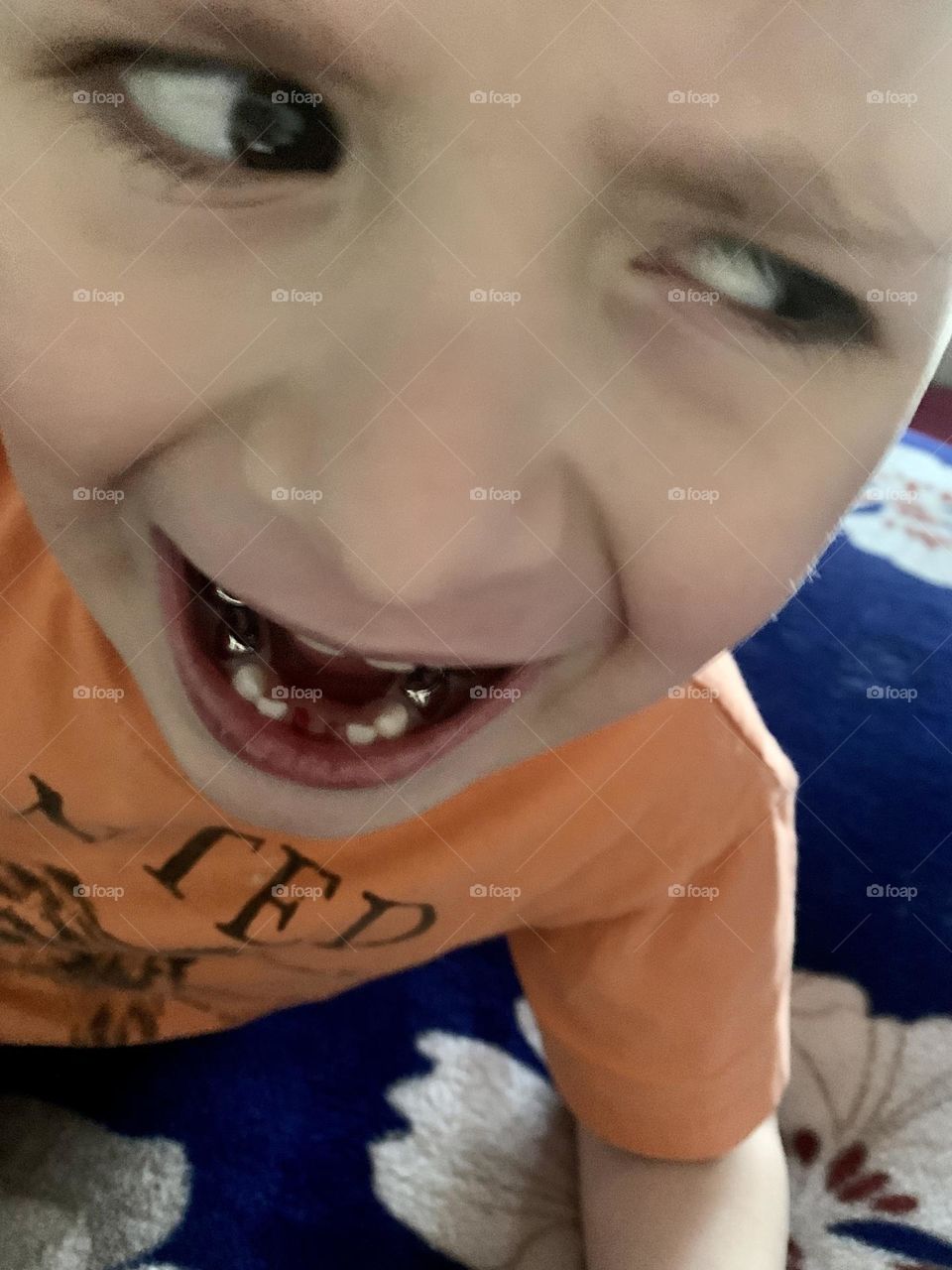 Little boy who lost a tooth looking disgusted 