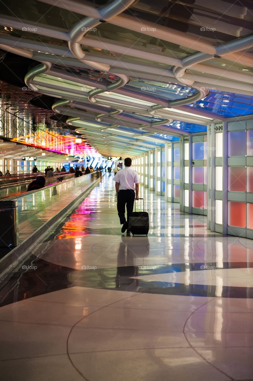 Man walking through airport terminal 