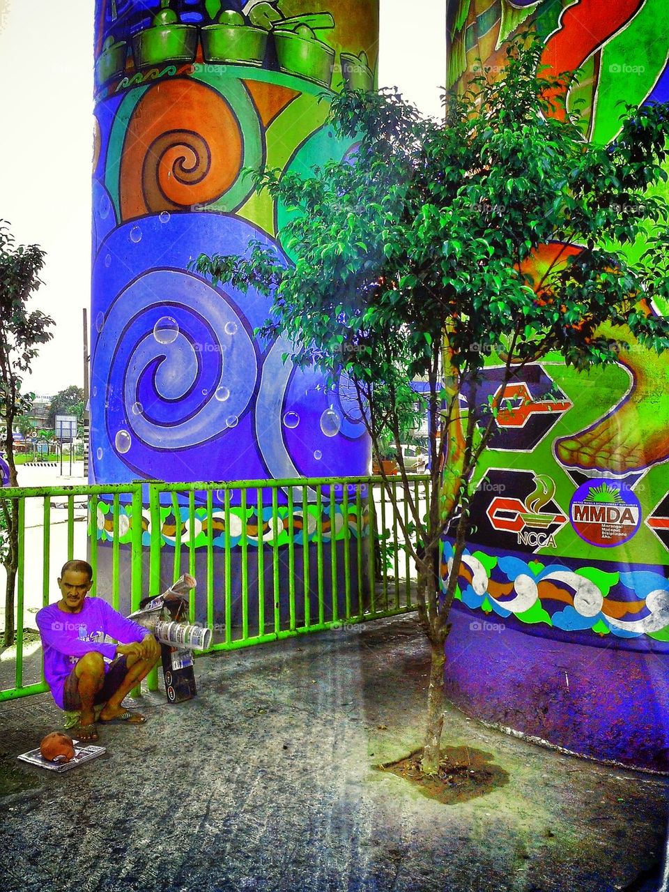 street vendor resting beside colorful pillars